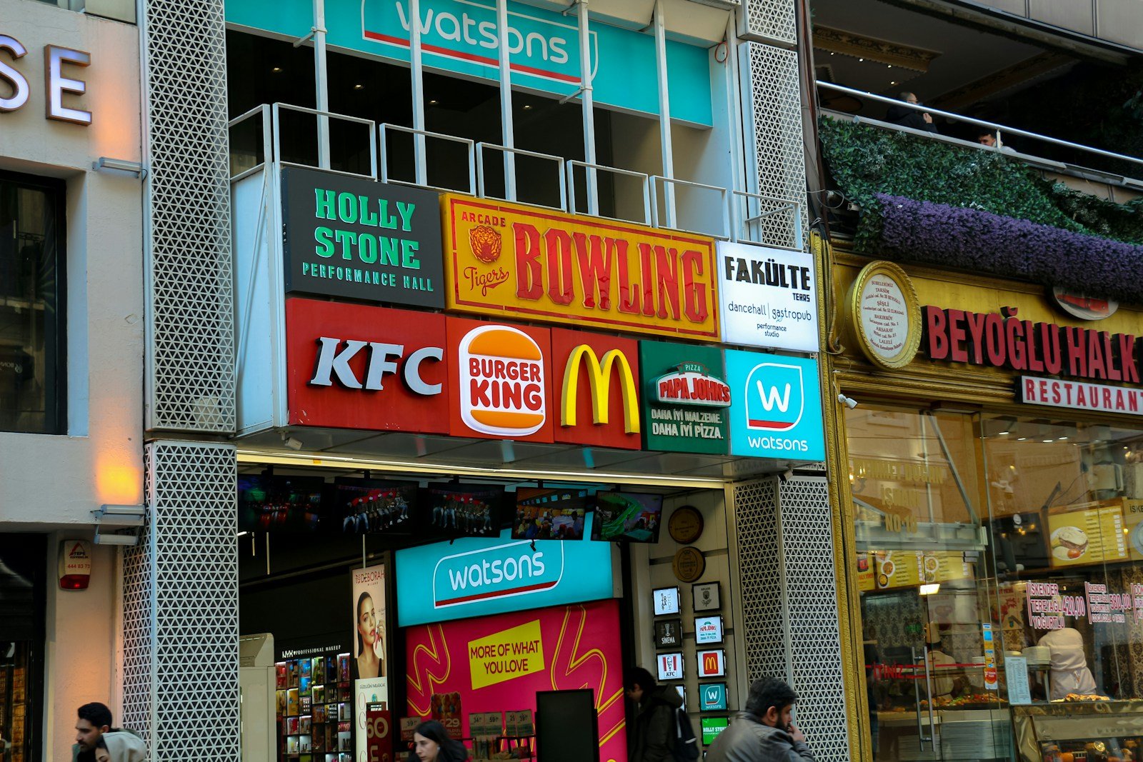 A street with several shop signs and stores.